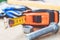 Steel bolts and nuts lie on wooden boards next to a tape measure ruler