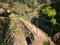 A steel cable safety fence protects tourists and hikers from a steep drop on a lavada walking trail near Monte in Funchal, Madeira