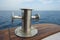 Steel capstan on side of a yacht at sea