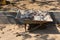 A steel cart in the construction site carries smashed bricks to be discarded for outdoor parking.