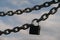 steel chain with a lock against the sky