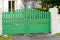 Steel classic green metal gate fence of house street view