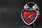 Steel clock alarm in the form of a heart with red hearts inside on a black glitter shiny background. Happy Valentine`s Day