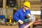 Steel construction worker cutting metal with angle grinder