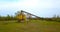 Steel containers with conveyor belt near a river