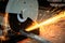Steel cutter grinder are cutting iron pipe with bright sparks