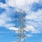 Steel electricity pylon on bright blue sky