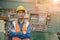 Steel factory staff worker portrait Asian man work in a heavy industrial machine with safety engineer uniform