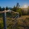 Steel fence in a farmland with sun rays in the background in Lier, Buskerud, Norway