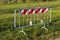 A steel fence with a red and white striped sign for roadside work in progress Italy, Europe