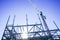 Steel framing and beams structural elements for new building against blue sky from low point of view.back-lit with sunburst and