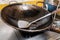 Steel frying spade on old pan on stove in kitchen for cooking