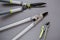 Steel Garden tool set on gray background.Secateurs, loppers and hedge trimmers.Garden equipment and tools.Tools for