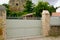 Steel green clear metal gate in street view of fence on modern house