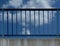 Steel guard rail with vertical pickets and posts along highway