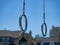 Steel gymnastic rings hanging at an outdoor gym in a residential