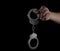 Steel handcuffs of police special equipment, fetters on a black background.