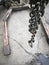 Steel hooks on steel chains, used for lifting and hauling heavy items in garages.