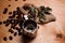 Steel kettle with coffee grains on the wooden table