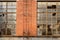Steel ladder on facade of deserted 1970s` red brick workshop
