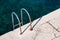 Steel ladder on pier with turquoise adriatic ocean in Triest