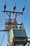 Steel mast carring high voltage powerline branch with transformer