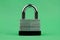 Steel Padlock on Green Background