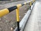 Steel pipe Guard rail painted with Yellow and Black enamel paint and acts as barrier or boundary lines of an asset owned