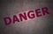 Steel plate background with danger text
