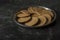 A steel plate full of English marie biscuits with dark background. Selective focus