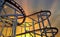 Steel rails for driving roller coasters in circular motions, on background evening sky and sun shining, concept relaxation and