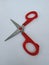 Steel and Red Color Small Single Scissor  on white Background