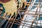 Steel reinforcement on construction site. Industrial construction worker using pliers and wire rod