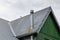 Steel roof of the old house with gutter and ventilation chimneys