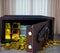 Steel safes box full of coins stack and gold bar