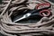 Steel scissors with plastic handle and a thick hemp rope. Close-up. Selective focus