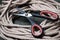 Steel scissors with a plastic handle and thick hemp rope. Close-up. Selective focus