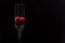 Steel shiny fork and red heart.