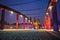 The steel structure of the bridge and the towers of the Gothic Catholic cathedral at night