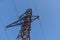 Steel structure of a power line support against a clear blue sky. Communication tower for power supply unit