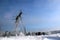 Steel structure of the power line  and winter forest on the hirizon