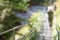 Steel suspension footbridge in mountains - image with natural extremely shallow depth of field