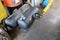 Steel tanks containing gas used to replace petrol fuel for installation in automobiles are placed on the floor in the garage.