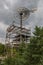 A steel tower with a large windmill, used to serve as a water pump.