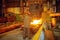 Steelmaker pours liquid metal from basket, factory