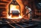 Steelmaker wearing protective clothe at ingot casting. Electric arc furnace shop. Metallurgy. steelmaker pours pig iron