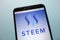 Steem cryptocurrency logo displayed on smartphone