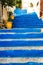 Steep alleyway with blue panted steps