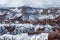 Steep canyon wall with hoodoos, trees and snow, Bryce Canyon