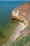 Steep clayey and shell rock shore overgrown with wild steppe vegetation on the island of Berezan, Ukraine